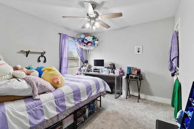 carpeted bedroom with ceiling fan and baseboards