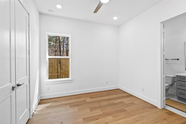 unfurnished bedroom with light wood-style floors, baseboards, ensuite bathroom, and recessed lighting