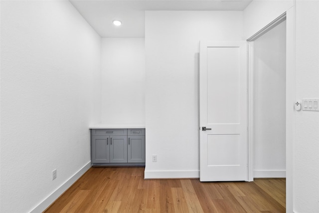 interior space with light wood-type flooring and baseboards