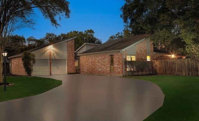 mid-century inspired home featuring an outbuilding, brick siding, a front yard, and fence