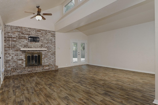 unfurnished living room with wood finished floors, a ceiling fan, baseboards, french doors, and a brick fireplace