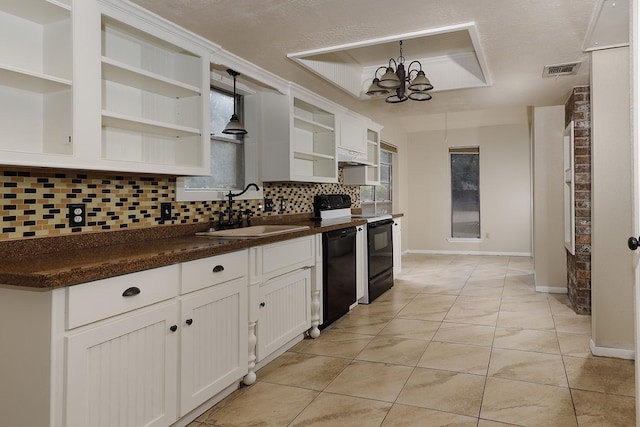 kitchen featuring black dishwasher, visible vents, dark countertops, open shelves, and a sink