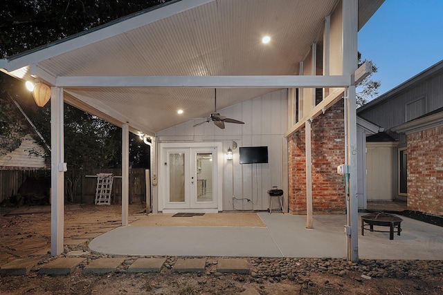 view of patio with french doors, ceiling fan, a fire pit, and fence