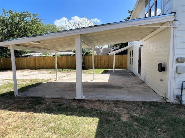 view of patio / terrace featuring a carport and fence