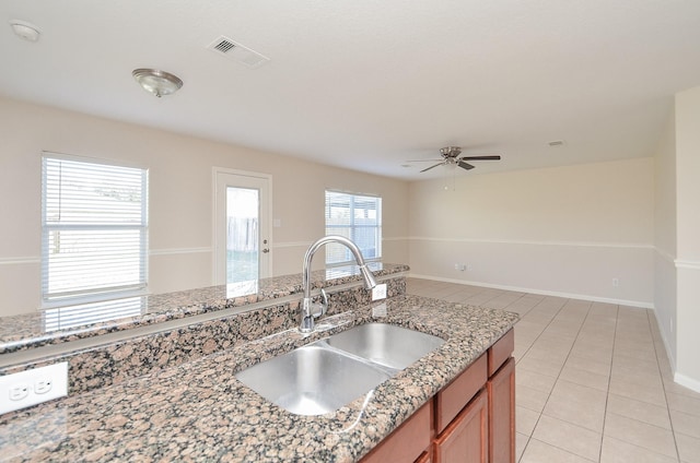26810 Blacktail Ct, Hockley, TX 77447 - kitchen featuring visible vents, light tile patterned floors, light stone counters, a ceiling fan, and a sink
