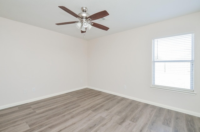 26810 Blacktail Ct, Hockley, TX 77447 - empty room featuring baseboards, a ceiling fan, and light wood finished floors