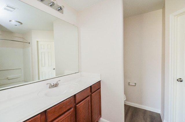 26810 Blacktail Ct, Hockley, TX 77447 - bathroom featuring visible vents, baseboards, toilet, wood finished floors, and vanity