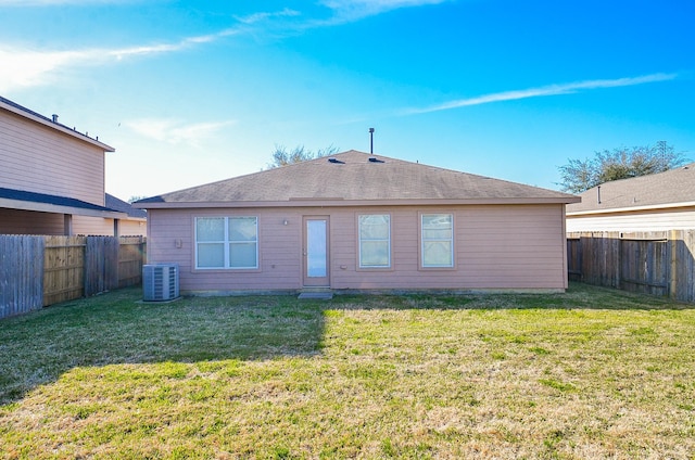 26810 Blacktail Ct, Hockley, TX 77447 - rear view of house featuring a lawn, a fenced backyard, central AC, and roof with shingles