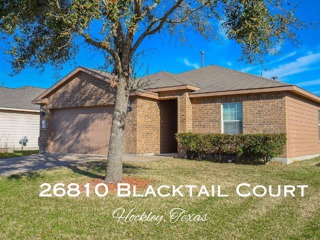 26810 Blacktail Ct, Hockley, TX 77447 - ranch-style home with a front lawn, an attached garage, brick siding, and driveway