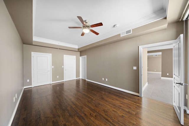 unfurnished bedroom featuring ornamental molding, wood finished floors, visible vents, and baseboards