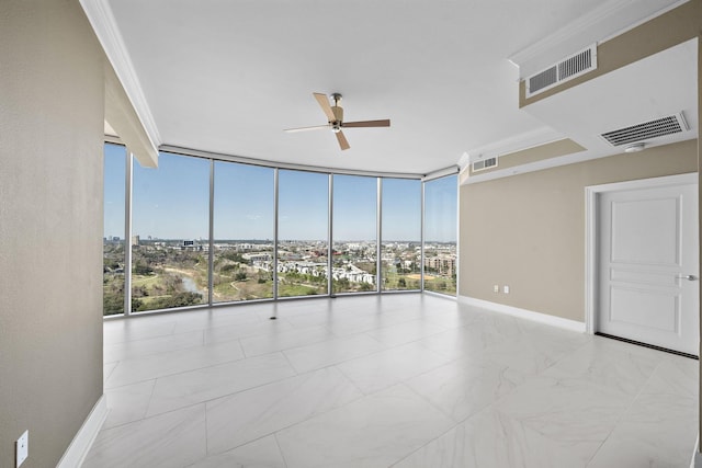 unfurnished room featuring a wall of windows, visible vents, and baseboards