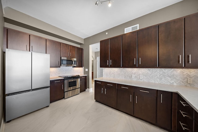 kitchen with dark brown cabinetry, stainless steel appliances, visible vents, marble finish floor, and light countertops