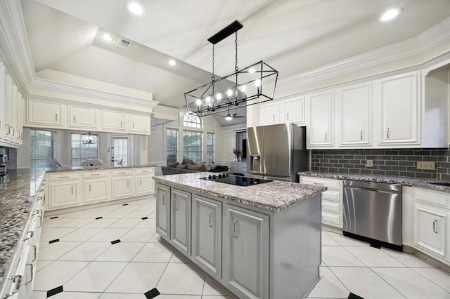 kitchen with appliances with stainless steel finishes, light tile patterned flooring, ornamental molding, and tasteful backsplash