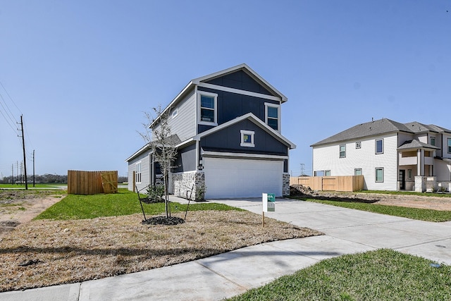 view of front of home featuring stone siding, concrete driveway, fence, and an attached garage