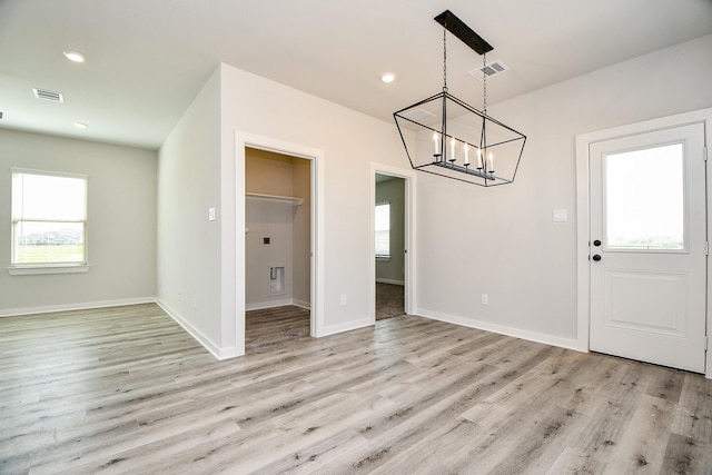 unfurnished dining area with baseboards, light wood finished floors, visible vents, and recessed lighting