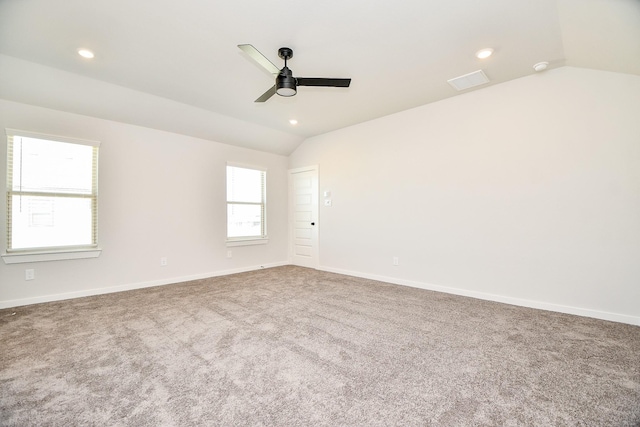 spare room with recessed lighting, visible vents, baseboards, vaulted ceiling, and carpet