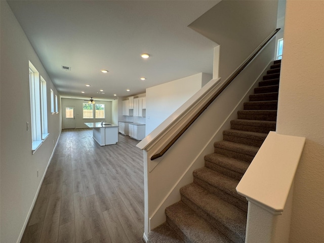 19126 Hazel Firs Ln, Magnolia, TX 77355 - stairs featuring wood finished floors, recessed lighting, and baseboards