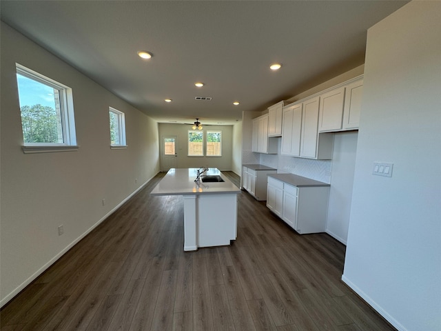 19126 Hazel Firs Ln, Magnolia, TX 77355 - kitchen featuring white cabinetry, recessed lighting, dark wood finished floors, and a kitchen island with sink