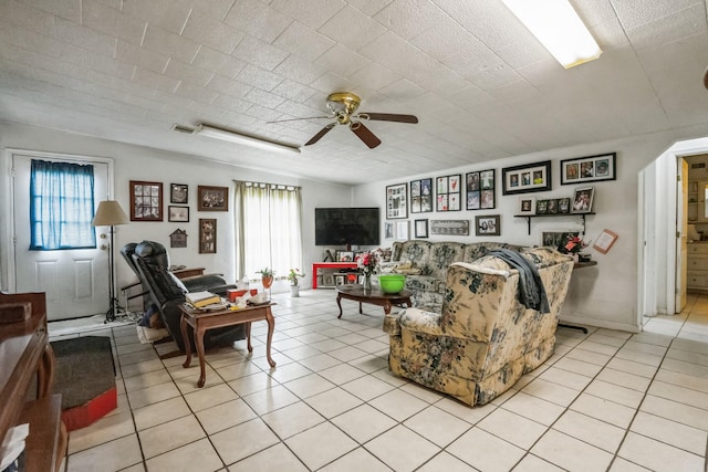 living room with light tile patterned floors, ceiling fan, and visible vents