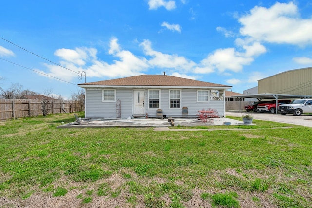 back of house with a patio, fence, a carport, and a yard