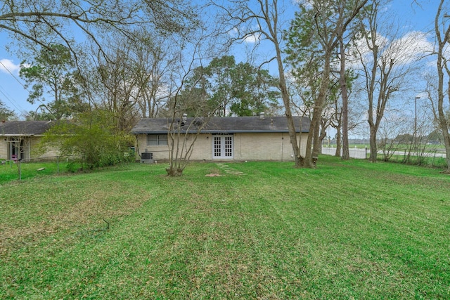 3230 Virginia St, La Marque, TX 77568 - view of yard with french doors, cooling unit, and fence