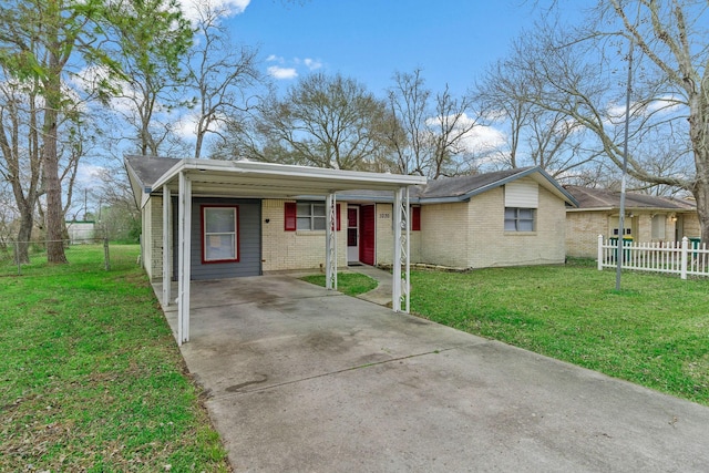 view of front of house featuring concrete driveway, a front lawn, fence, and brick siding