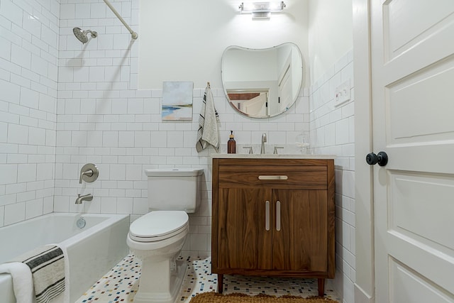 bathroom with toilet, tub / shower combination, tile walls, and vanity