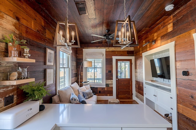 living room with plenty of natural light, wood ceiling, and wooden walls