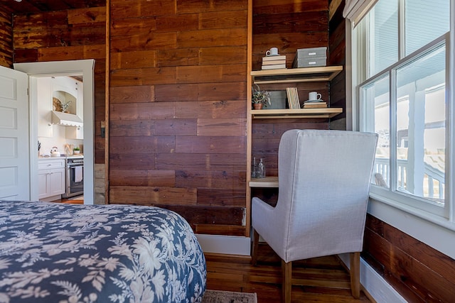 bedroom with wood finished floors and wooden walls