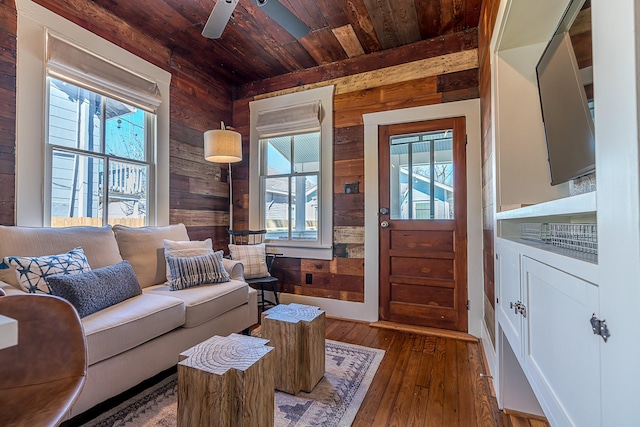 living room featuring a wealth of natural light, wood ceiling, wood walls, and wood-type flooring