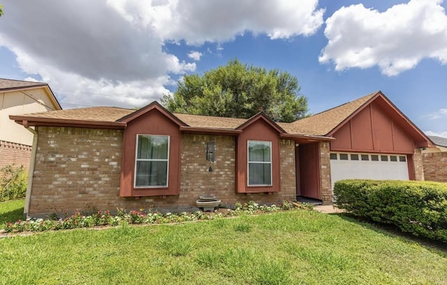 single story home with an attached garage, a front lawn, and brick siding