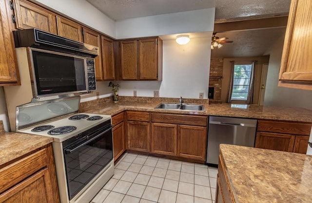 kitchen featuring electric range, stainless steel dishwasher, a sink, a textured ceiling, and ceiling fan