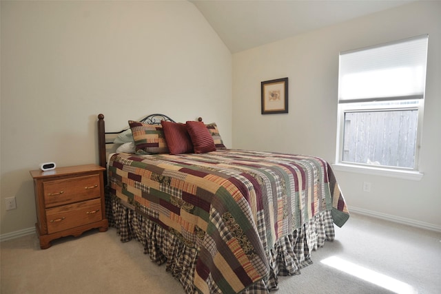 bedroom featuring baseboards, vaulted ceiling, and light colored carpet