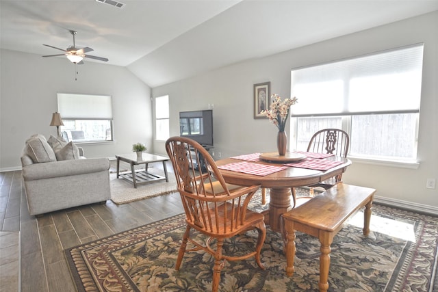 dining room with wood tiled floor, visible vents, vaulted ceiling, and baseboards