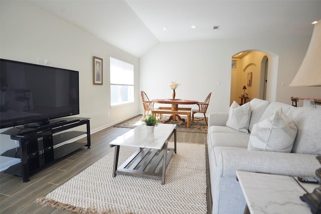 living area with arched walkways, baseboards, wood finished floors, and lofted ceiling