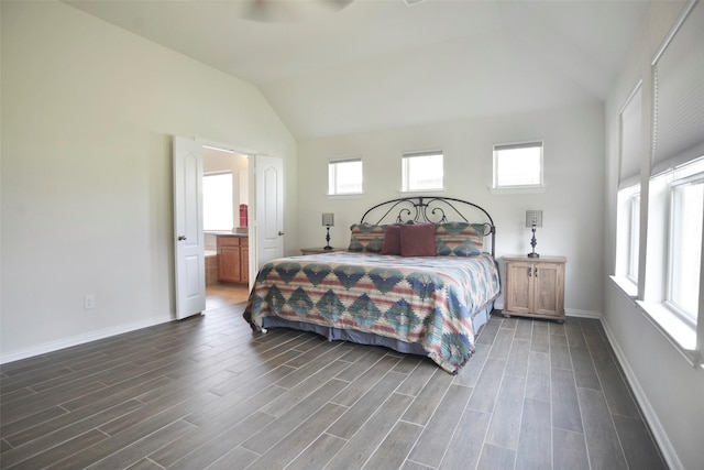 bedroom with ensuite bathroom, baseboards, vaulted ceiling, and wood finish floors