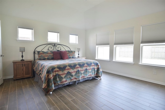 bedroom featuring dark wood finished floors and baseboards