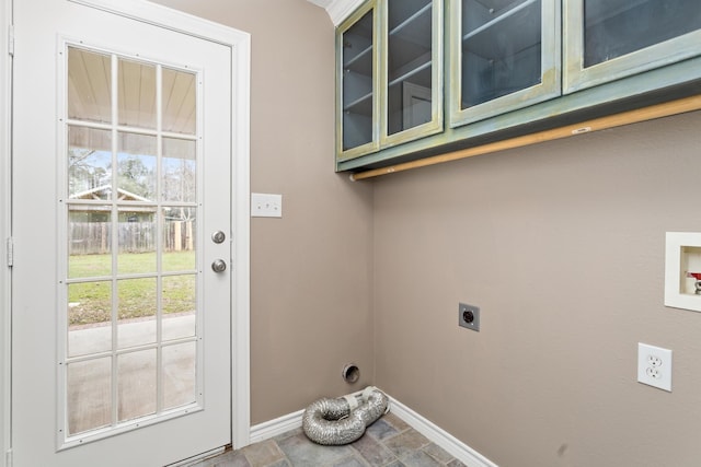 laundry room with cabinet space, stone finish flooring, baseboards, and hookup for an electric dryer