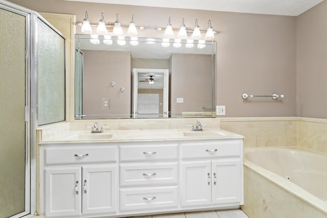 bathroom with double vanity, a sink, a bath, and a shower stall