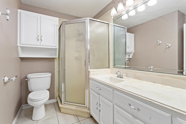 bathroom with a stall shower, baseboards, toilet, tile patterned flooring, and vanity