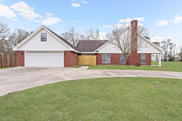 view of front of home with fence, a front lawn, concrete driveway, and brick siding