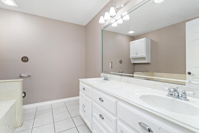 bathroom featuring double vanity, tile patterned flooring, a sink, and baseboards