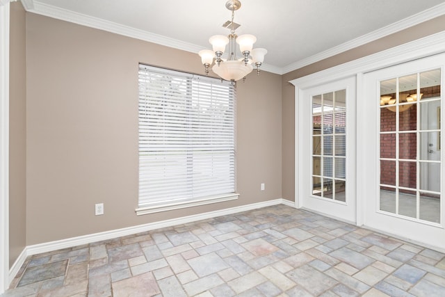 empty room with ornamental molding, stone finish floor, and a notable chandelier