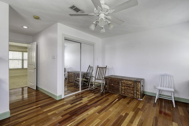 bedroom featuring baseboards, visible vents, and wood-type flooring