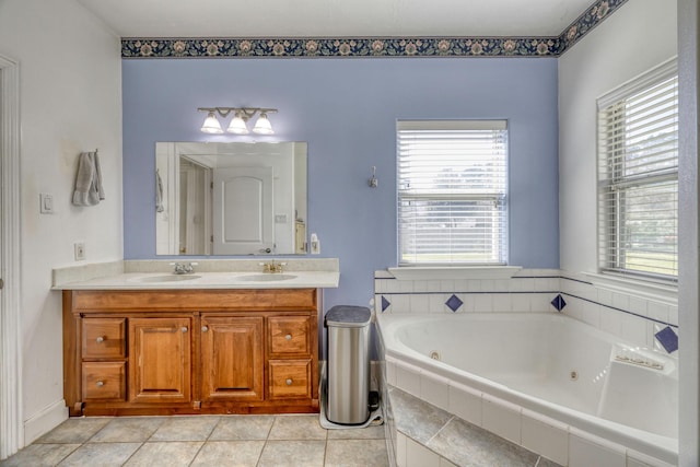 bathroom with tile patterned flooring, a healthy amount of sunlight, double vanity, and a whirlpool tub