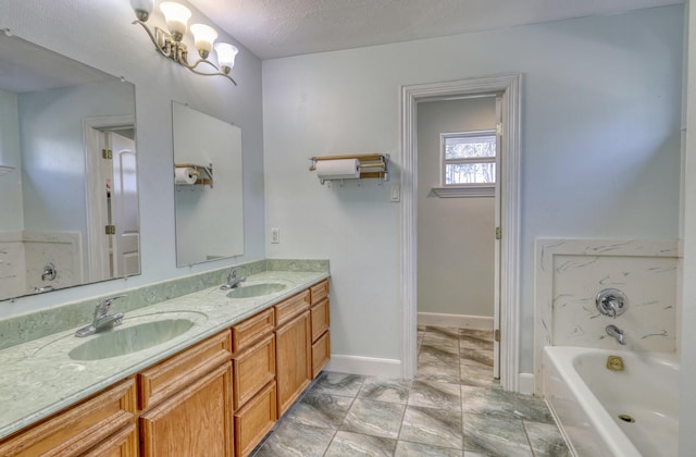 full bathroom featuring double vanity, a bath, baseboards, and a sink