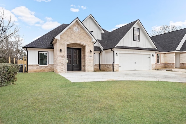 view of front of house featuring driveway, a garage, roof with shingles, a front lawn, and brick siding