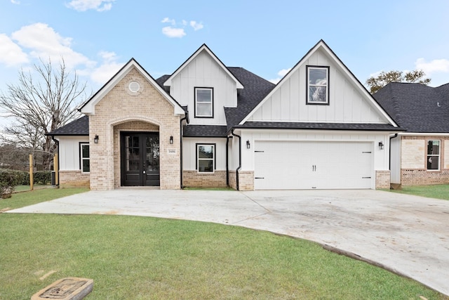 modern inspired farmhouse featuring a shingled roof, brick siding, driveway, and a front lawn