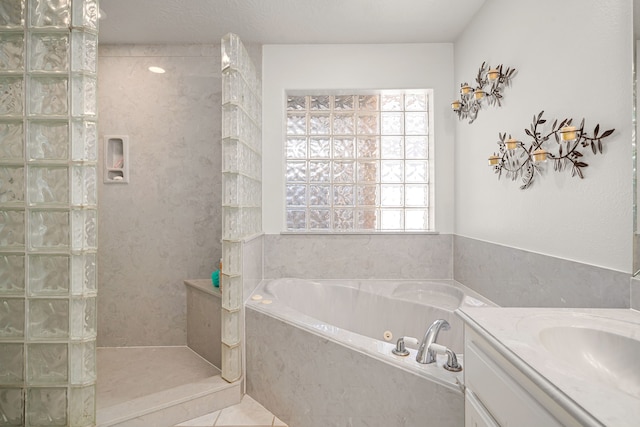 full bath with a garden tub, tile patterned flooring, walk in shower, and vanity