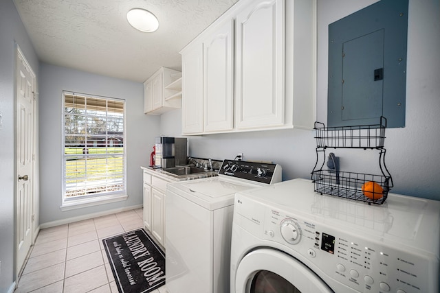 laundry room featuring cabinet space, light tile patterned floors, electric panel, independent washer and dryer, and a sink